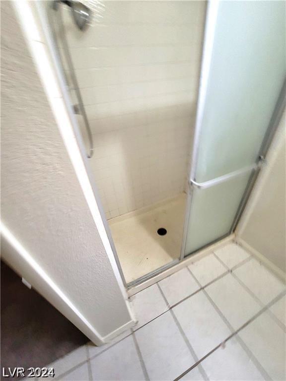 bathroom featuring tile patterned flooring and walk in shower