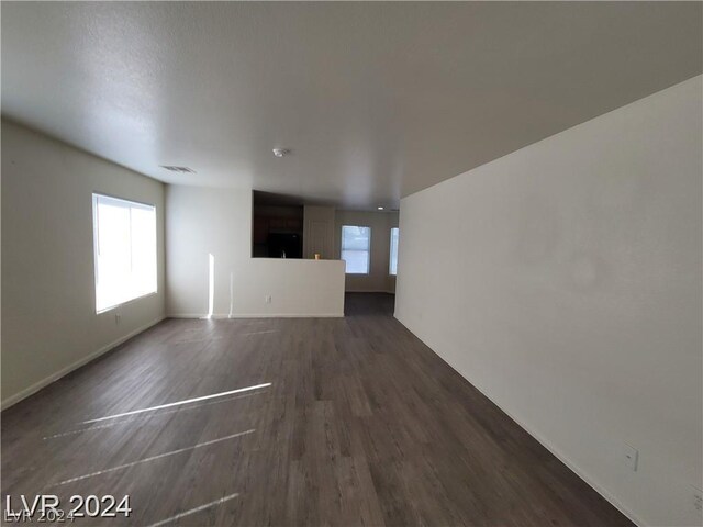 unfurnished living room featuring dark wood-type flooring