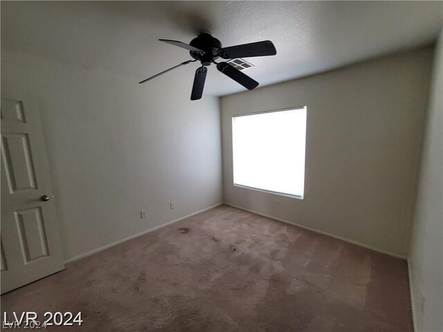 spare room with carpet and ceiling fan