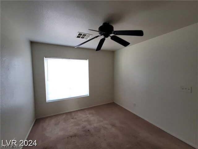 unfurnished room with carpet floors and ceiling fan