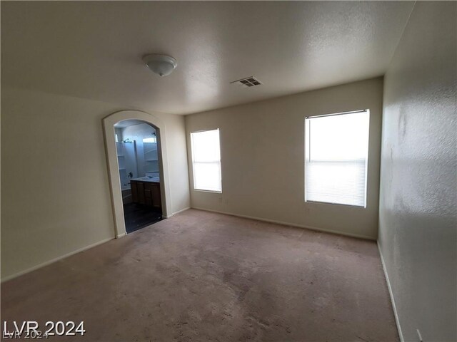 spare room with carpet floors and a textured ceiling