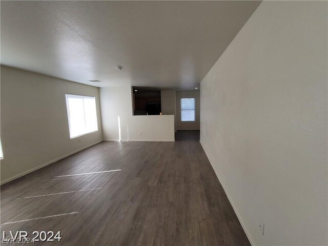 unfurnished living room featuring dark hardwood / wood-style flooring