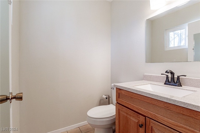 bathroom featuring vanity, tile patterned flooring, and toilet