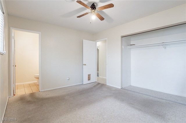 unfurnished bedroom featuring light carpet, ceiling fan, ensuite bath, and a closet