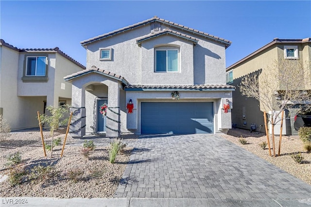 mediterranean / spanish-style home featuring a garage