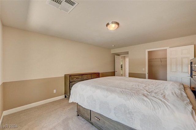 bedroom featuring a closet, visible vents, baseboards, and carpet floors