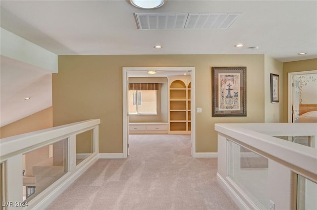 hallway with recessed lighting, visible vents, baseboards, and light colored carpet