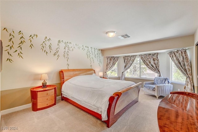 carpeted bedroom featuring visible vents and baseboards