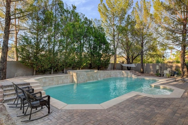 view of pool featuring a patio area, a fenced backyard, a fenced in pool, and an in ground hot tub