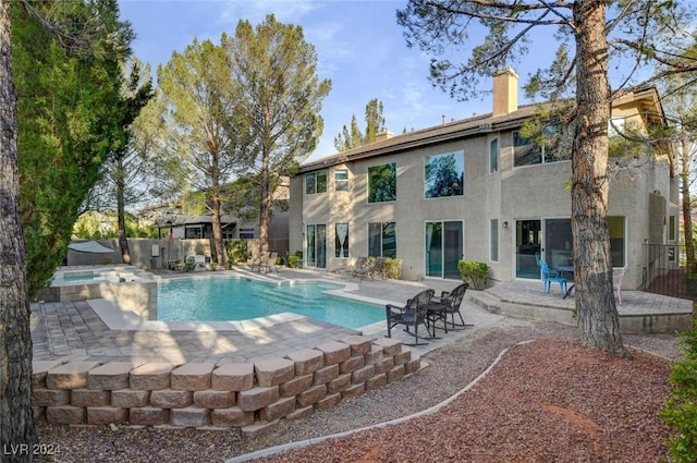 view of pool with a pool with connected hot tub and a patio area