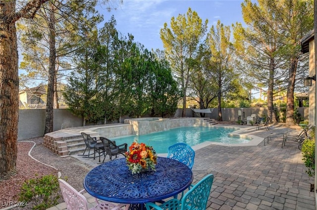 view of swimming pool with outdoor dining area, a patio area, a fenced in pool, and a fenced backyard