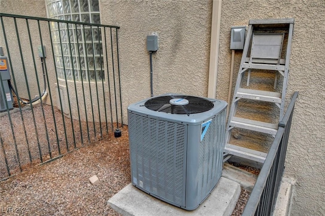 details featuring central AC unit and stucco siding