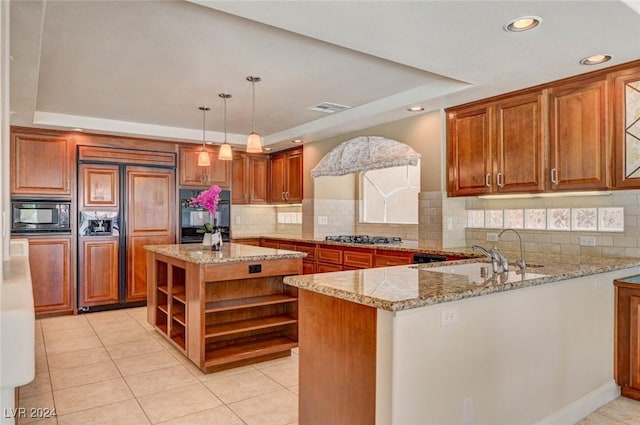 kitchen featuring a tray ceiling, open shelves, built in appliances, and a sink