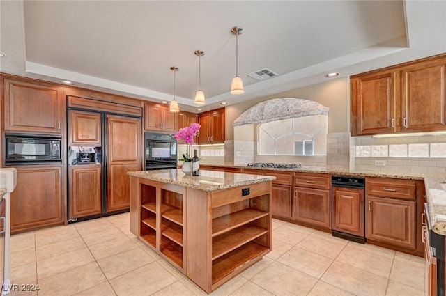 kitchen featuring visible vents, light stone countertops, a tray ceiling, black appliances, and open shelves