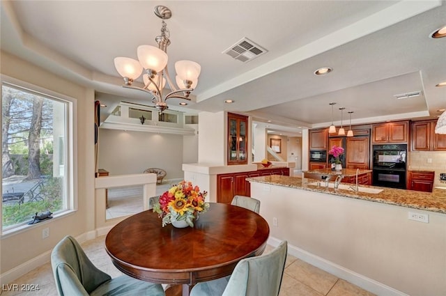 dining room featuring visible vents, baseboards, a tray ceiling, light tile patterned floors, and recessed lighting