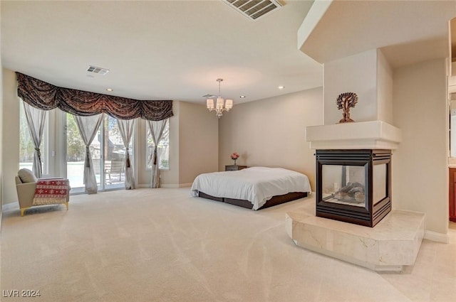 carpeted bedroom with access to outside, recessed lighting, visible vents, and a multi sided fireplace