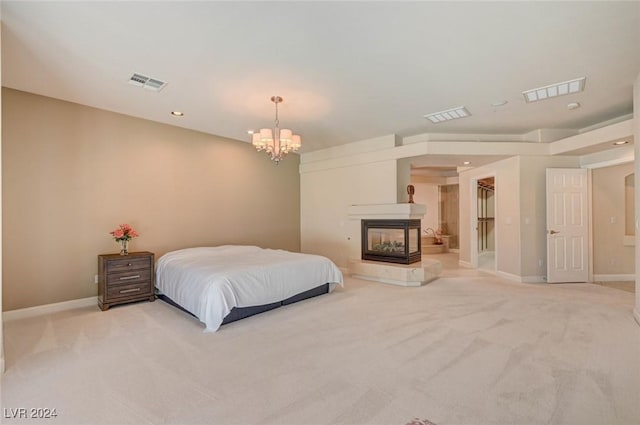 carpeted bedroom featuring a multi sided fireplace and a chandelier