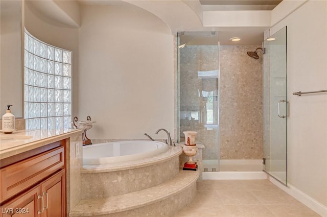 full bath with tile patterned floors, a stall shower, vanity, and a garden tub