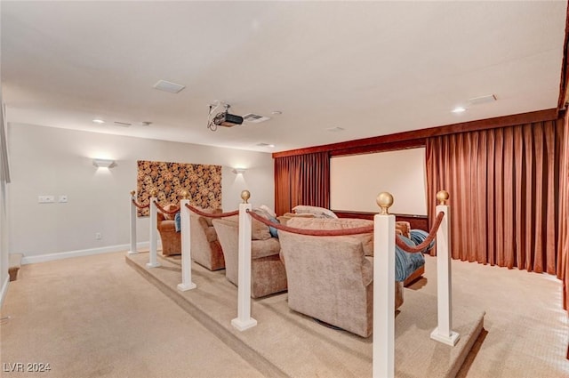 home theater room featuring light colored carpet