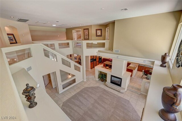 living room with visible vents, recessed lighting, and a glass covered fireplace