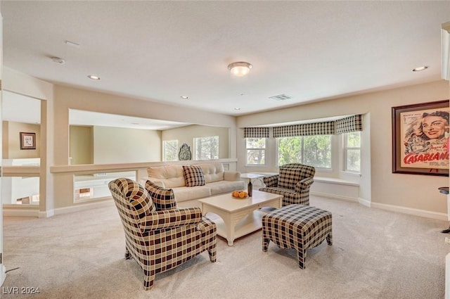 living room featuring recessed lighting, visible vents, light colored carpet, and baseboards