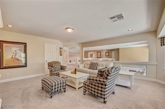 living room with recessed lighting, visible vents, baseboards, and light colored carpet