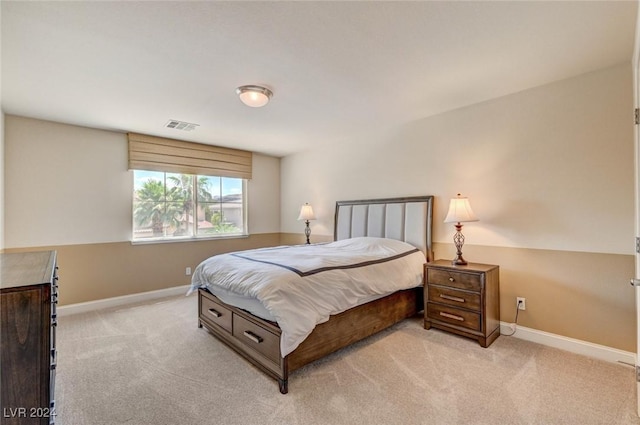 bedroom featuring visible vents, light colored carpet, and baseboards