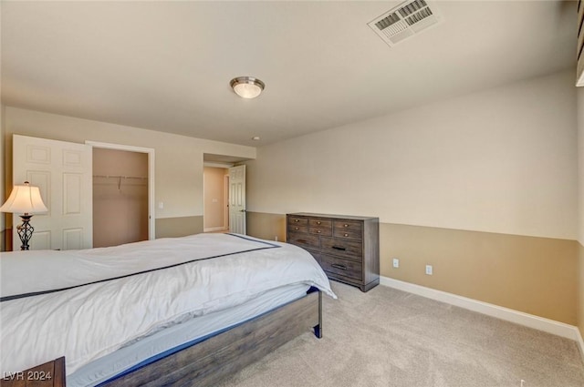 bedroom with a closet, visible vents, baseboards, and carpet