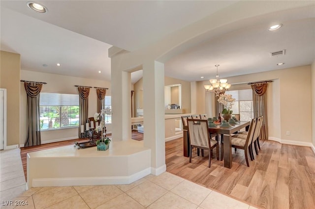 dining area with light tile patterned floors, visible vents, baseboards, recessed lighting, and a notable chandelier