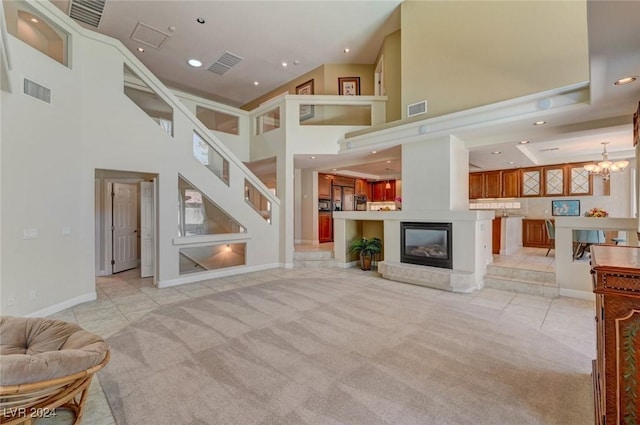 living room featuring a high ceiling, light tile patterned floors, and a notable chandelier