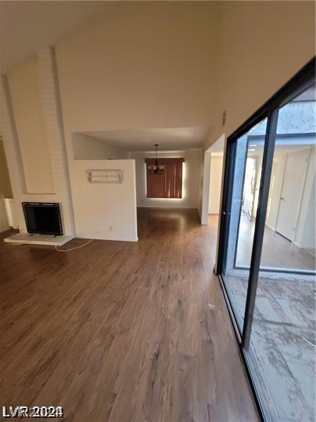 unfurnished living room featuring hardwood / wood-style flooring and a large fireplace