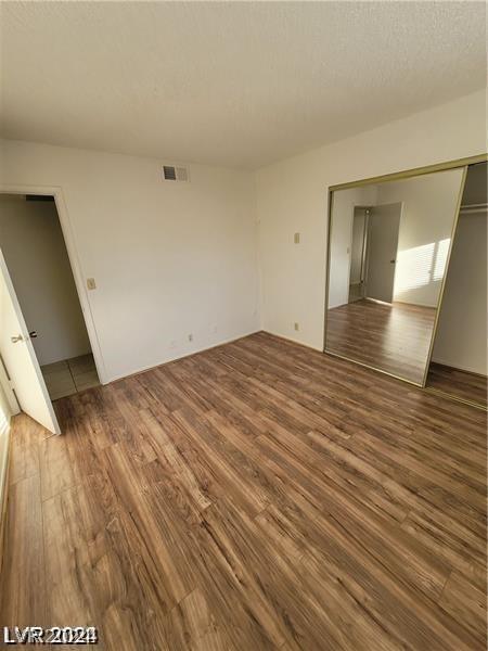 spare room with wood-type flooring