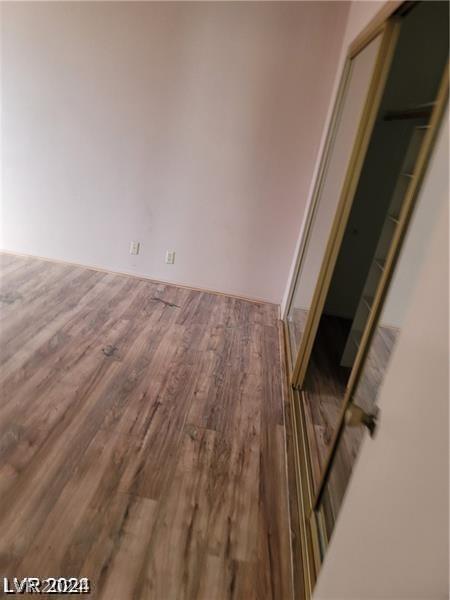 empty room with hardwood / wood-style floors