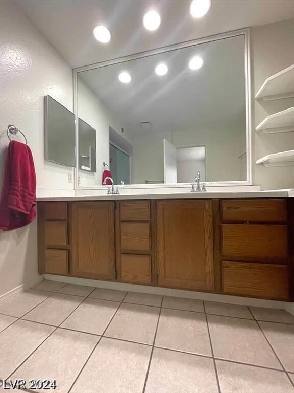 bathroom featuring tile patterned flooring and vanity