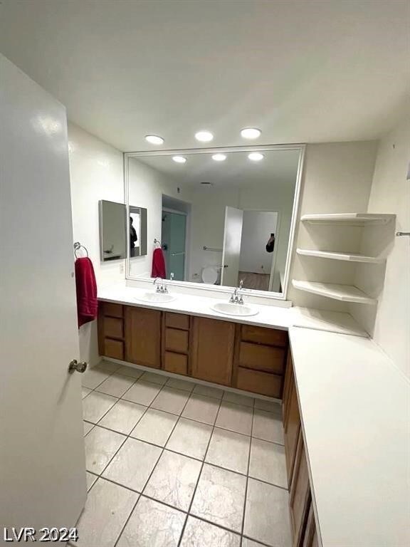 bathroom featuring tile patterned flooring and dual bowl vanity