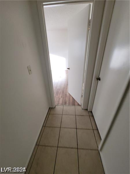 corridor with light hardwood / wood-style floors