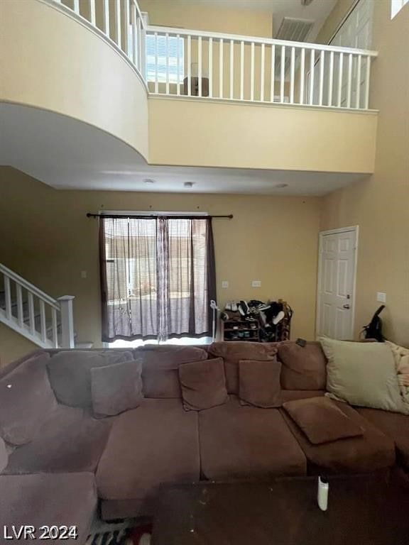 living room featuring a high ceiling