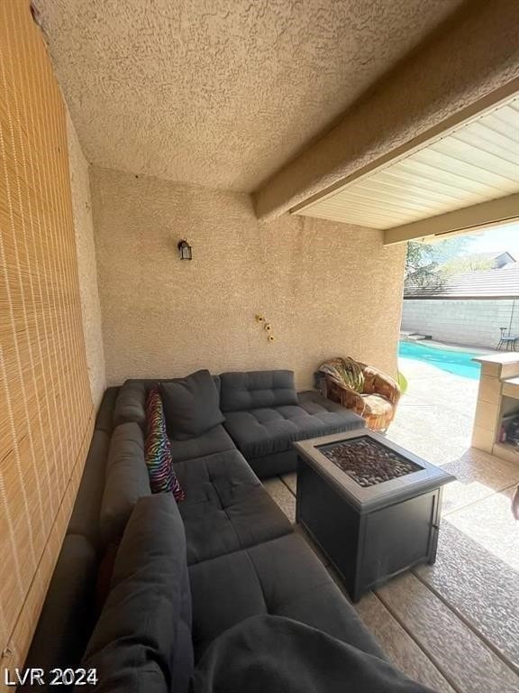 view of patio / terrace with an outdoor living space with a fire pit and a fenced in pool