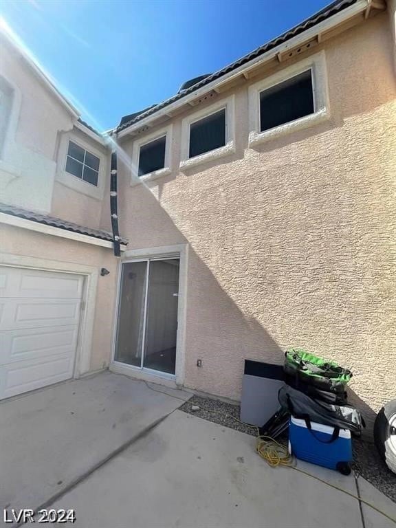 rear view of house featuring a garage