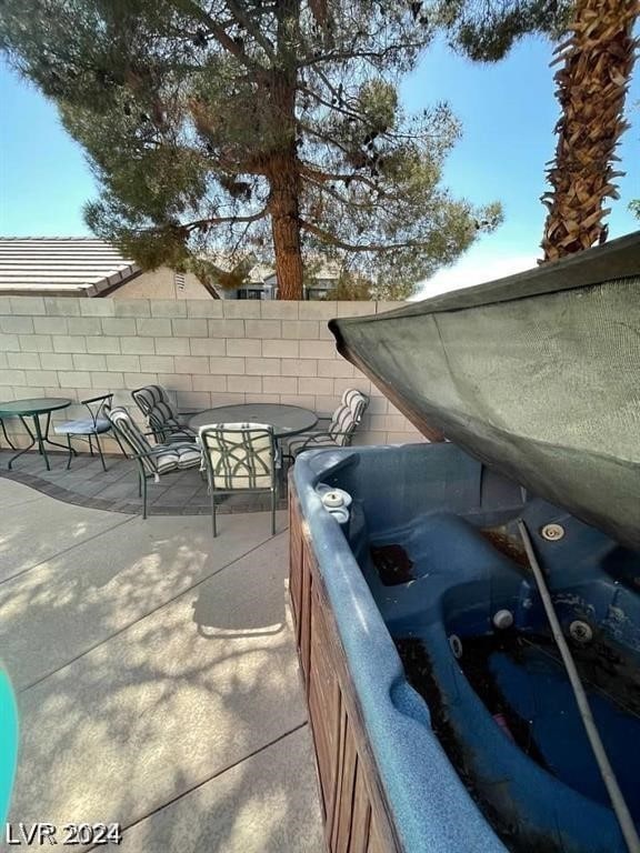 view of patio / terrace with a hot tub