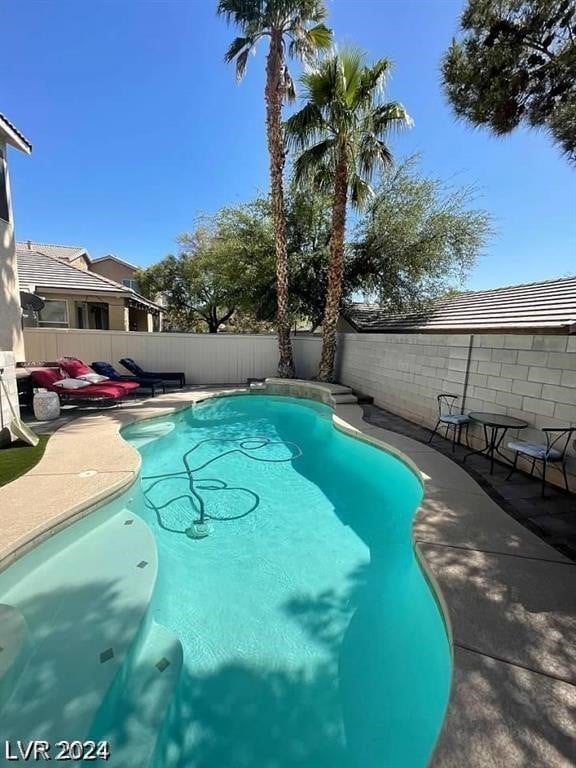 view of swimming pool featuring a patio area