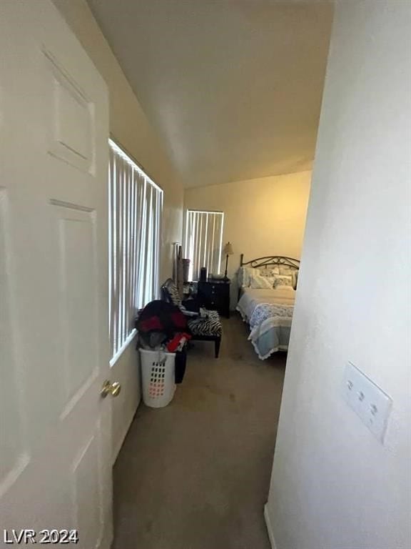 bedroom featuring carpet flooring and vaulted ceiling