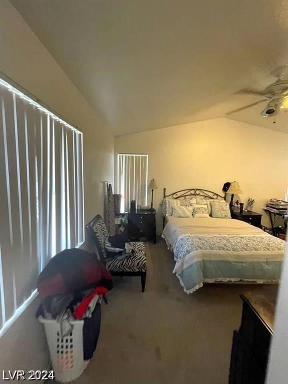 carpeted bedroom with lofted ceiling and ceiling fan