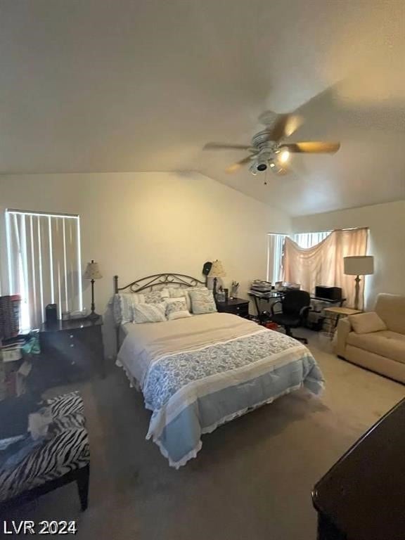 bedroom featuring multiple windows, ceiling fan, carpet flooring, and vaulted ceiling