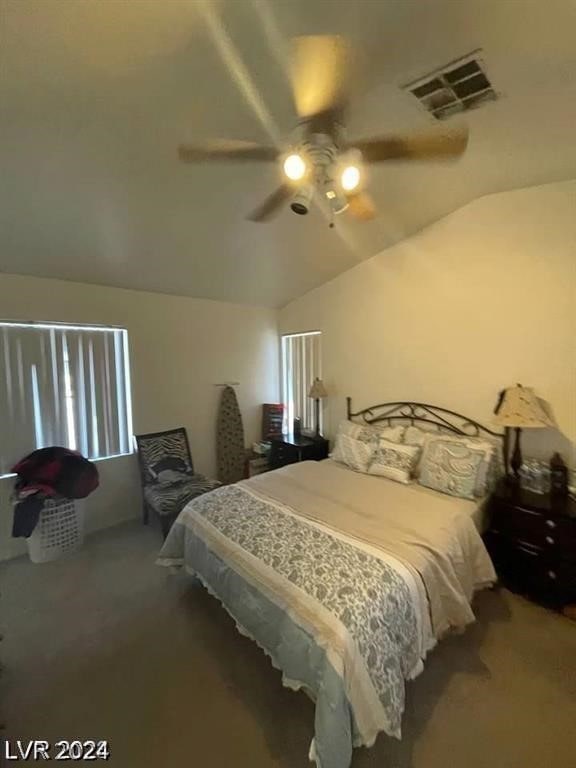 carpeted bedroom with lofted ceiling and ceiling fan