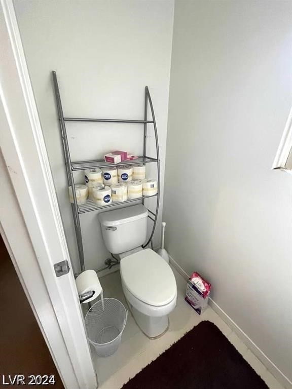 bathroom with toilet and tile patterned flooring