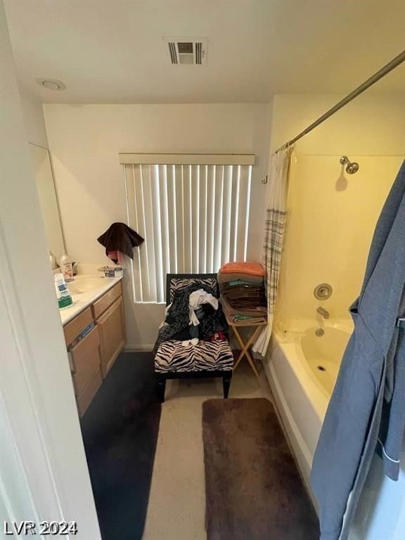 bathroom with shower / tub combo and vanity