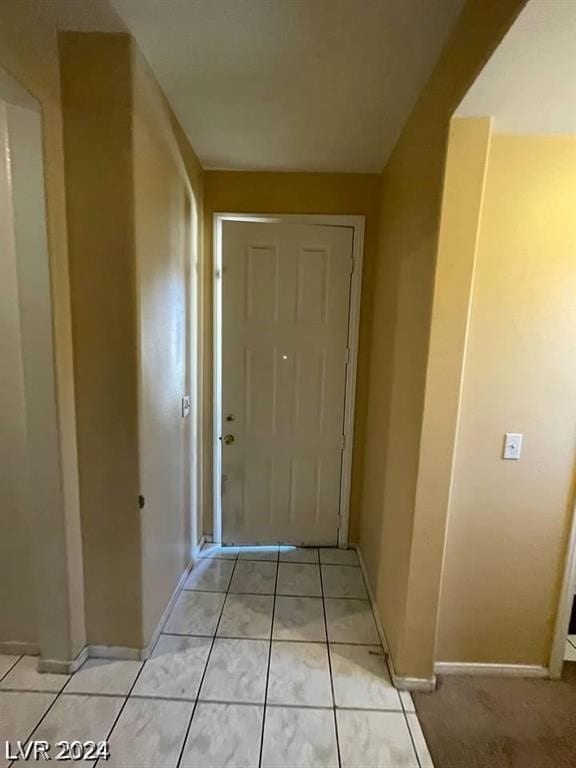 hall featuring light tile patterned floors