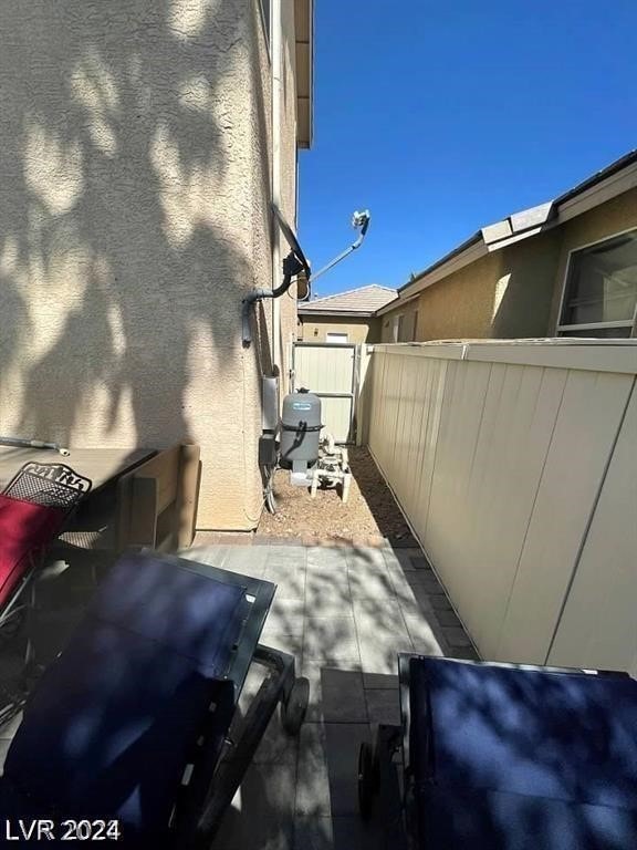 view of property exterior with a patio area