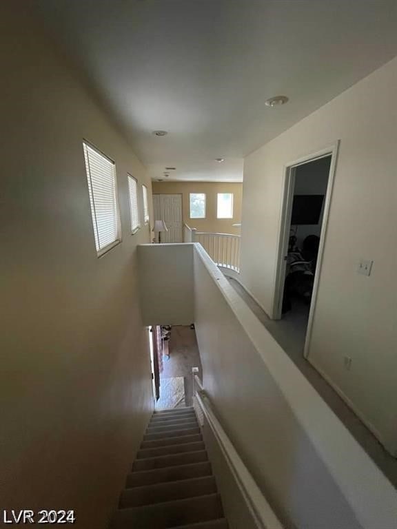 stairs featuring hardwood / wood-style floors